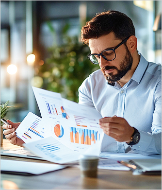 Analyst reviewing sales reports with charts